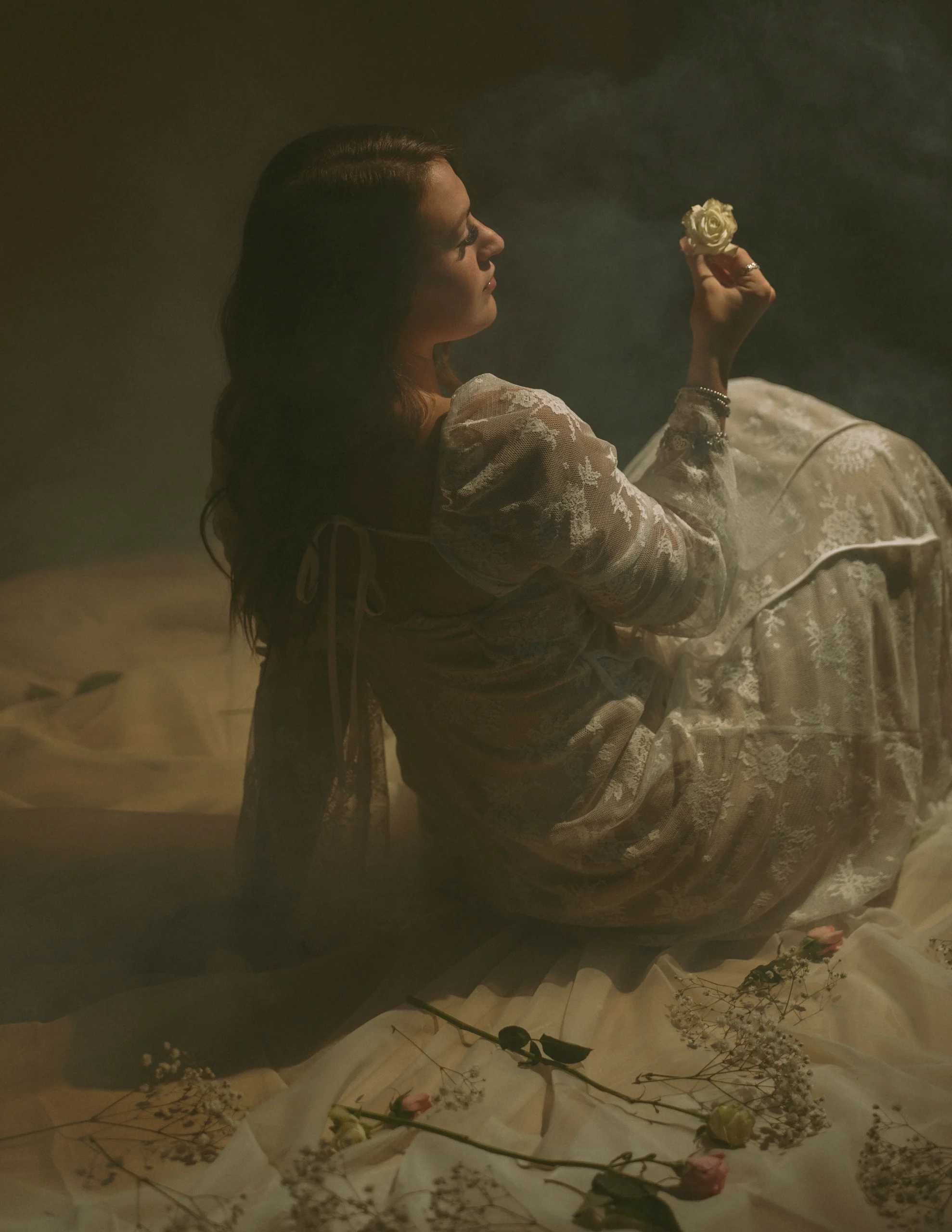 Woman in white dress looking at flowers